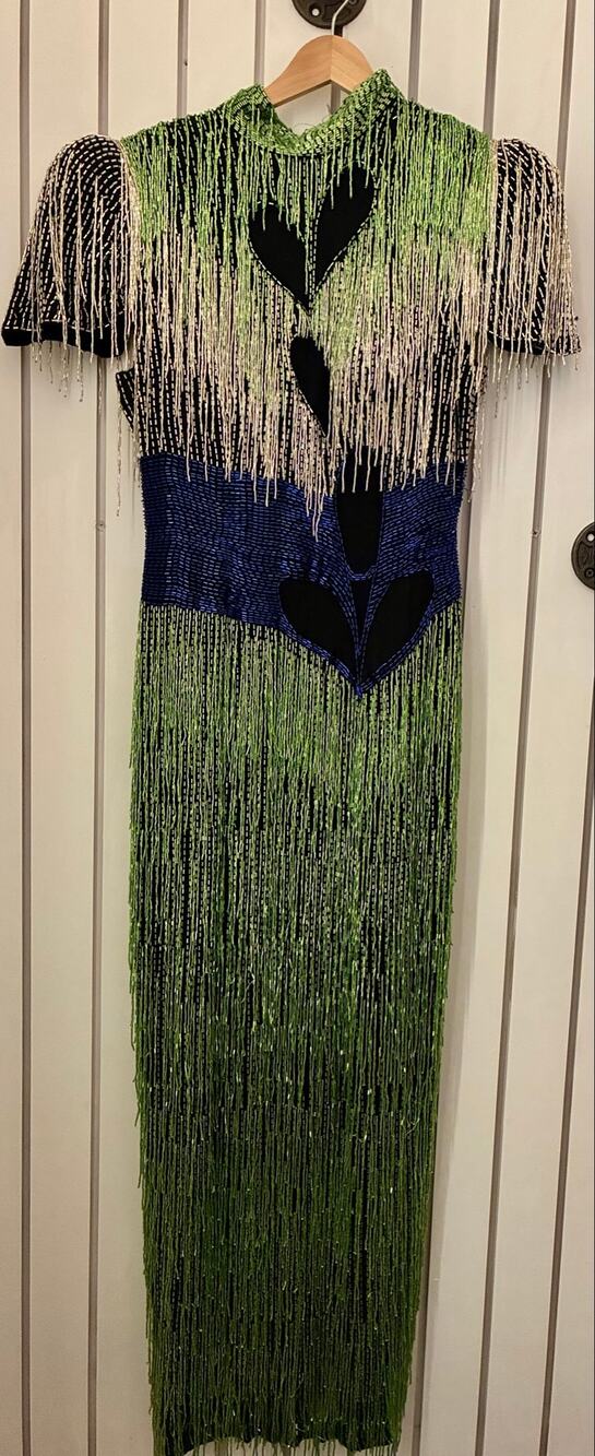 Striking vintage dress features vibrant green and silver beaded fringe